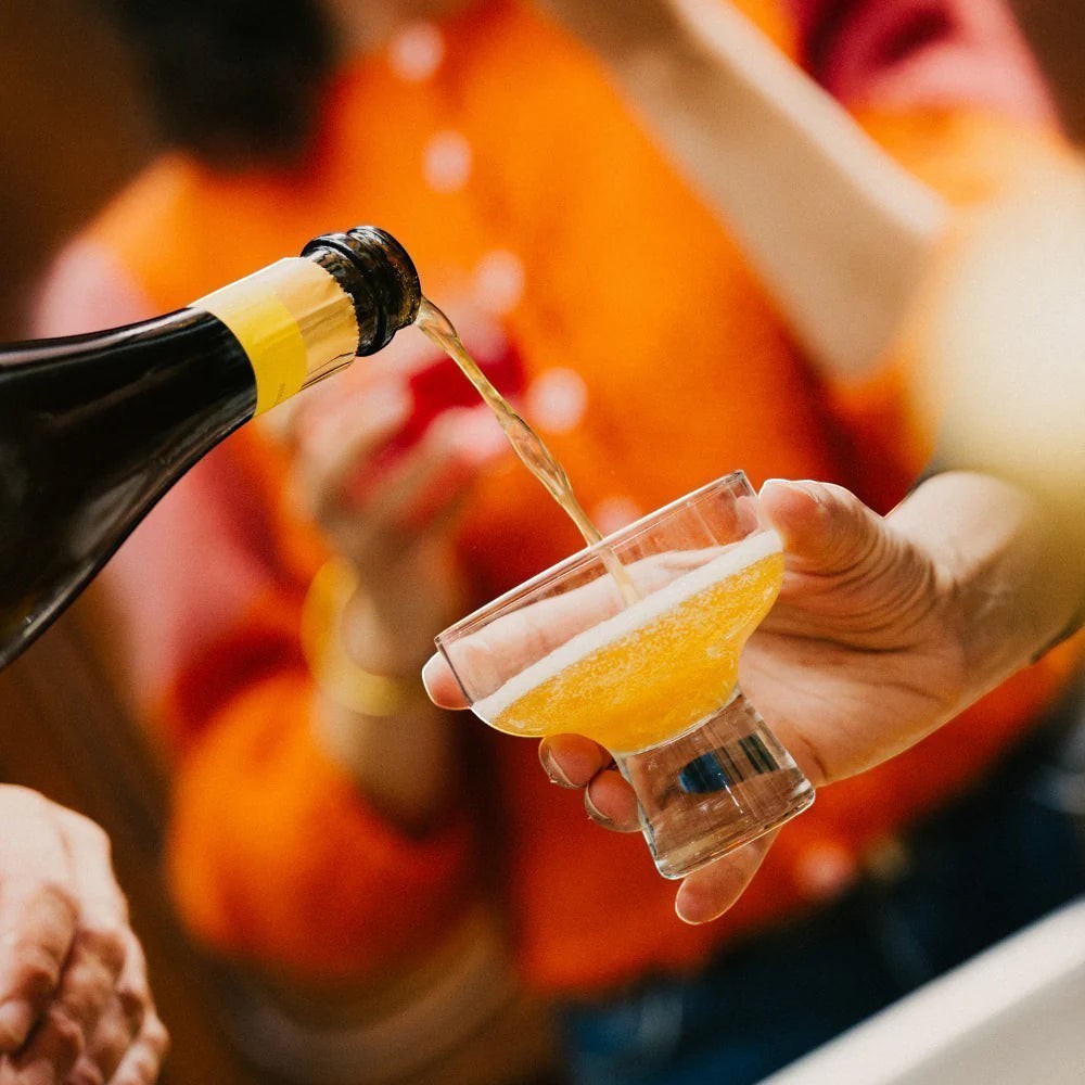 OSCO L'Éclat Brut sparkling drink bottle served in a cocktail glass.